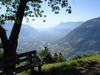 A scenic view of the town of Meran nestled in the mountains.