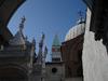 A view of the Cathedral of St. Mark&apos;s in Venice showing some of the saints adorning its roof, and a peek at its bell tower.