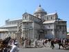 Side view of the Cathedral of Santa Maria of the Assumption in Cathedral Plaza in Pisa. It was built in Pisan Romanesque style by the master Rainaldo using gray marble and white stone.