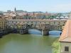 The Ponte Vecchio (Old Bridge) spans the Arno River in Florence at its narrowest point. The current structure dates to 1345. As it has for centuries, the bridge still houses shops on either side of the roadway.
