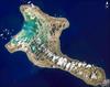 Pronounced "Ki-ris-mas," Kiritimati Island has a large infilled lagoon that gives it the largest land area of any atoll in the world. Captain Cook named the atoll Christmas Island when he arrived on Christmas Eve in 1777. Used for nuclear testing in the 1950s and 1960s, the island is now valued for its marine and wildlife resources. It is particularly important as a seabird nesting site, with an estimated 6 million birds using or breeding on the island, including several million Sooty Terns. Rainfall on Kiritimati is linked to El Nino patterns, with long droughts experienced between the wetter El Nino years. This image is a mosaic of four digital photographs taken on 16 January 2002 from the Space Station. Photo courtesy of NASA.