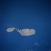 Although small in size (122 sq mi-316 sq km), the independent republic of Malta is strategically located midway between the Strait of Gibraltar and the Suez Canal in the Mediterranean Sea. The country is made up of three inhabited islands that are visible in this image: the island of Malta, the largest, Gozo, and Comino, the smallest (situated between the two larger islands). The capital and largest city, Valletta, is mainly built around a rocky peninsula, arrow-shaped peninsula extends northeast between two natural harbors (small, narrow, dark features). The geological faulting in this area has produced numerous fine natural harbors around the periphery of Malta. Although the islands are composed of sedimentary rocks, mainly limestone and clays, the alkaline soils provide fertile conditions for the well-established agricultural economy. Precipitation amounts can be a problem in that the islands average only about 32 cm (12 in) per year. Malta has few natural resources so the growth of tourism, especially since World War II, has gradually added to the Maltese economy. Photo courtesy of NASA.