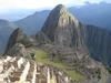 Many of the former housing units of the city of Machu Picchu are visible in the foreground of this image.