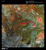The prominent crimson streak in the center of this false-color satellite image represents the remains of a 50 km (31 mi) lahar (volcanic mudflow) that cut a strip of barren rock through rich vegetation surrounding the Anyuyskiy Volcano. The currently dormant volcano is the orange circular shape at the right end of the streak. Remote and largely inaccessible, the Kamchatka Peninsula is a rugged collection of towering volcanic peaks, steep valleys, active geysers, and wild, snow-fed rivers and streams.  This volcano is part of the UNESCO World Heritage Site &quot;Volcanoes of Kamchatka.&quot; For other active volcanoes in Russia, see the Natural hazards-volcanism subfield in the Geography section. Image courtesy of USGS.