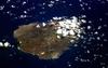 An oblique view of rugged Ascension Island, which is is barren in many places and has no indigenous human population. Instead the residents of the island are there because of Ascension's main industry: communications. The island has a long history as a communications hub for telephone and radio communications and as a base for satellite tracking stations, including a NASA station built in the 1960s that no longer operates. The European Space Agency operates a tracking station for its Ariane spacecraft on the eastern side of the island.
Ascension Island is one of the most important breeding grounds for seabirds in the tropical Atlantic Ocean. The population of seabirds has been under threat since the first humans sailed up to the island in the 1500s. The ships accidentally introduced black rats, which overran the island, until cats were introduced to curb the rat population. The feral cats have decimated the bird populations, and in fact, are probably responsible for the extinction of two of the islands native land birds. A restoration project is underway to control the cat population and revive the seabirds. Image courtesy of NASA.