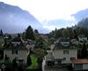 Sturdily built Swiss homes lie in the shadows of some imposing mountains.
