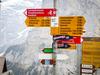 Way signs in Murren, a traditional mountain village in Bernese Oberland, unreachable by public road. The village features a view of the three towering mountains: Eiger, Monch, and Jungfrau. At an elevation of 1,650 m (5,413 ft), access to the village is via four cable cars known as Luftseilbahn-Stechelberg-Murren-Schilthorn (LSMS), which also provide access to the summit of Schilthorn, the location of a rotating restaurant with spectacular views.
