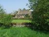 Typical Cotswolds hills cottage and dry stone walls.