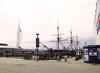 HMS Warrior docked in Portsmouth Harbor, England. The city's iconic Spinnaker Tower, opened in 2005, appears at the left. The tower's height is 170 m (560 ft); it has three viewing decks at 100-, 105-, and 110-meter levels.