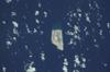 Jarvis Island is an uninhabited 4.5 sq km (1.75 sq mi) coral island located in the South Pacific Ocean. Unlike most coral atolls, the central lagoon on Jarvis is wholly dry. Note the submerged reef beyond the eastern shore of the island (top). Image courtesy of NASA.