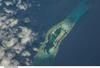 Palmyra Atoll is an unoccupied equatorial Northern Pacific atoll of some 12 sq km (4.6 sq mi) administered by the US Government. It is located almost due south of the Hawaiian Islands, roughly halfway between Hawaii and American Samoa. The atoll consists of an extensive reef, two shallow lagoons, and some 50 sand and reef-rock islets and bars covered with vegetation. The variable temporary population of 4 to 20 &quot;non-occupants&quot; consists of staff and scientists employed by various departments of the US Government and The Nature Conservancy, as well as a rotating mix of Palmyra Atoll Research Consortium scholars pursuing research. Photo courtesy of NASA.