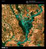 Small, blocky shapes of towns, fields, and pastures surround the graceful swirls and whorls of the Mississippi River shown in this false-color satellite image. Countless oxbow lakes and cutoffs accompany the meandering river south of Memphis, Tennessee, on the border between Arkansas and Mississippi. The &quot;Mighty Mississippi&quot; is the largest river system in North America. Image courtesy of USGS.