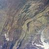 This regional view shows the striking visual effect of the valley-and-ridge topography of the Appalachian Mountains as viewed from the International Space Station. The image shows more than 500 km (300 mi) of this low mountain chain from northeast Pennsylvania (top right) to southern West Virginia, where a dusting of snow covers a patch of land (lower left).
Sunglint reflections reveal details of the Chesapeake Bay and the great bend of the Potomac River. Cities are difficult to detect from space during daylight hours, so the sickle-shaped bend of the river is a good visual guide for astronauts trying to photograph the nation's capital, Washington D.C. The farm-dominated Piedmont Plateau is the light-toned area between the mountains and the bay.
The Appalachian Mountains appear striped because the ridges are forested, providing a dense and dark canopy cover, while the valleys are farmed with crops that generally appear as lighter-toned areas. (Farmland is even lighter than usual in this image because the fields are fallow after the harvest.) Photo courtesy of NASA.