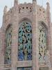 Closeup of the upper part of the Singing Tower at Bok Tower Gardens National Historic Landmark. The limestone structure includes tile mosaics, animal carvings, and custom iron-work.