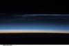 Polar mesospheric clouds (also known as noctilucent clouds) are transient, upper atmospheric phenomena observed usually in the summer months at high latitudes (greater than 50 degrees) of both the Northern and Southern Hemispheres. They are bright and cloudlike in appearance while in deep twilight. They are illuminated by sunlight when the lower layers of the atmosphere are in the darkness of the Earth's shadow. This image was acquired from the International Space Station at an altitude of just over 320 km (200 mi) in the pre-dawn hours. Image courtesy of NASA.