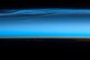 Polar mesospheric clouds - also known as noctilucent or "night shining" clouds - form between 76 to 85 km (47 to 53 mi) above the Earth's surface, near the boundary of the mesosphere and thermosphere, a region known as the mesopause. At these altitudes, water vapor can freeze into clouds of ice crystals. When the sun is below the horizon and the ground is in darkness, these high clouds may still be illuminated, lending them their ethereal, "night shining" qualities.
Polar mesospheric clouds have been observed from all human vantage points in both the Northern and Southern Hemispheres - from the surface, in aircraft, and from spacecraft - and tend to be most visible during the late spring and early summer. Image courtesy of NASA.