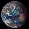 This "blue marble" image of the globe draws on data from multiple satellite missions (not all collected at the same time). The focus in this view is the North Atlantic Ocean and its surrounding land masses. Notice the thick ice pack on Greenland (top center) and the city lights on the night side of the globe. Image courtesy of NASA.