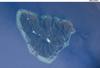 The tropical island of Moorea as viewed from the International Space Station. The barrier reefs surrounding the island create zones of shallow, tranquil light blue waters. Image courtesy of NASA.